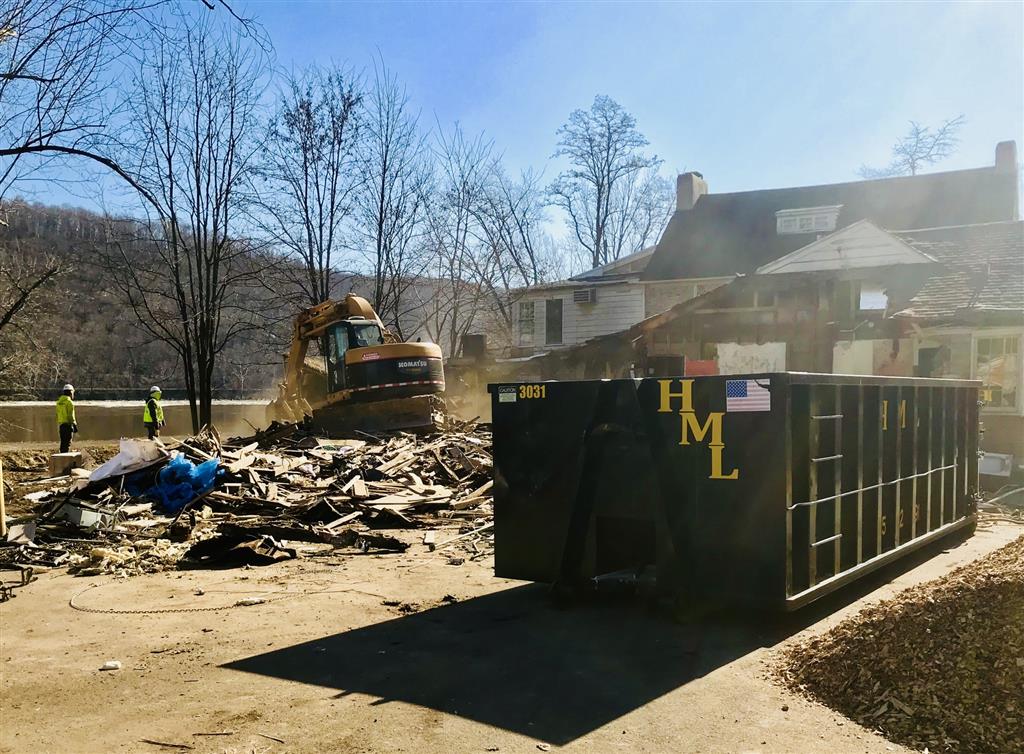 A construction dumpster outside a house